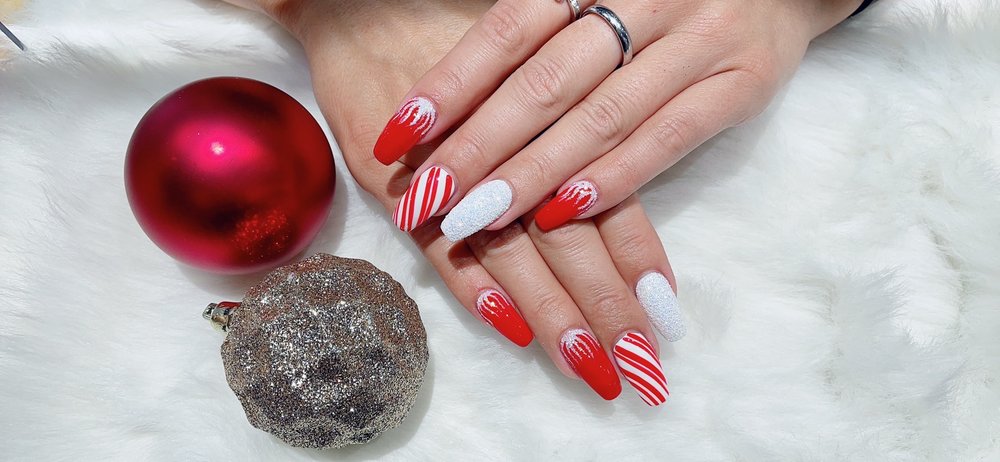 Red and white holiday candy cane nail design at Pleasant Nails & Spa