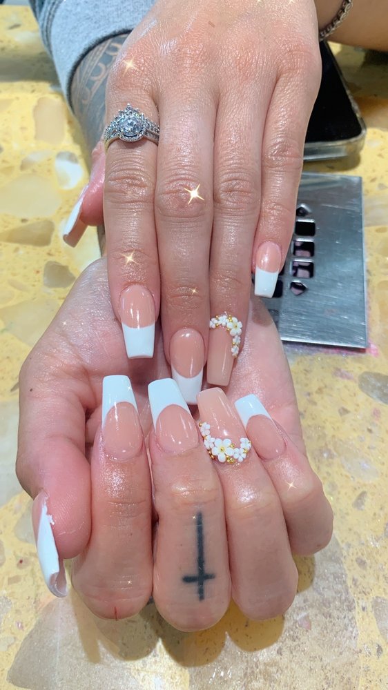 Classic French manicure with white flower accents at Pleasant Nails & Spa