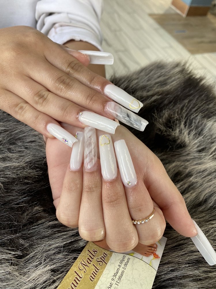 Long white acrylic nail set with gold accents at Pleasant Nails & Spa