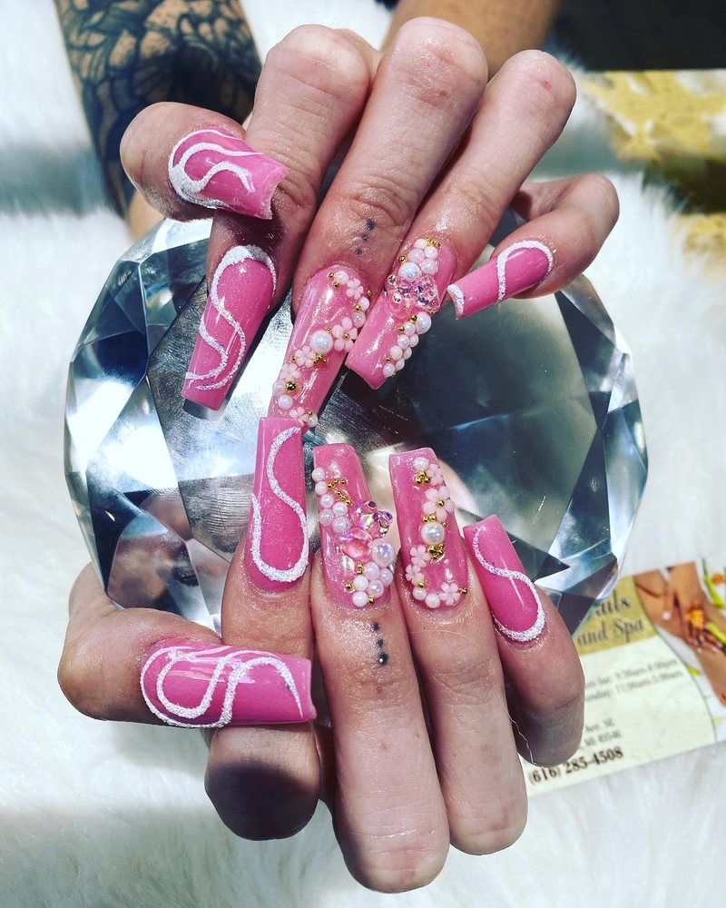 Pink coffin nails with pearls and 3D flower nail art by Pleasant Nails & Spa