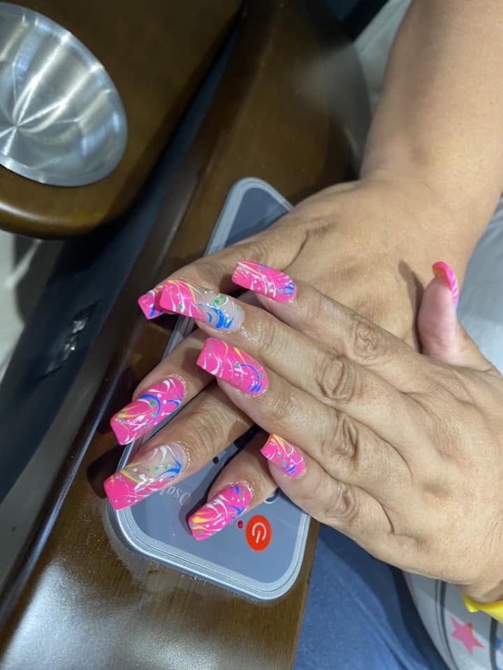 Bright pink nails with colorful swirl nail art at Pleasant Nails & Spa