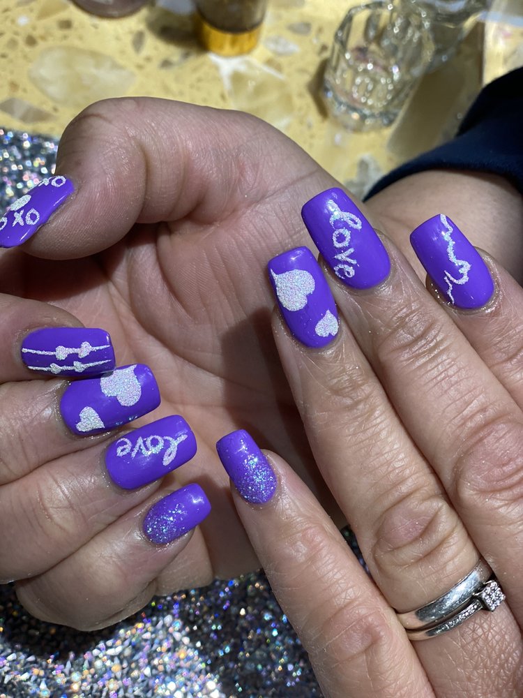 Purple nails with glitter hearts and love script design at Pleasant Nails & Spa