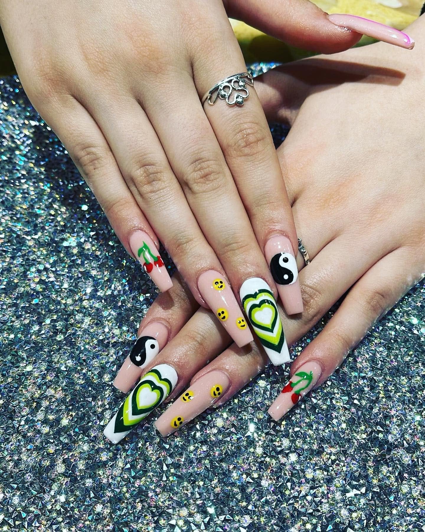 Hand-painted nail art design with hearts, smiley faces, and cherries by Pleasant Nails & Spa